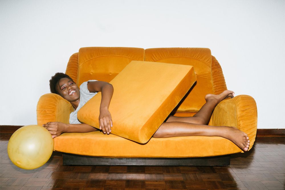 large_woman-lying-on-orange-sofa-3621486.jpg